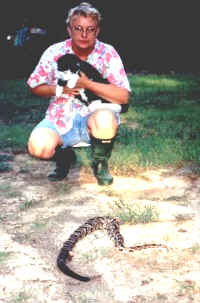 A close encounter - - Linda with her cat who found this timber rattlesnake